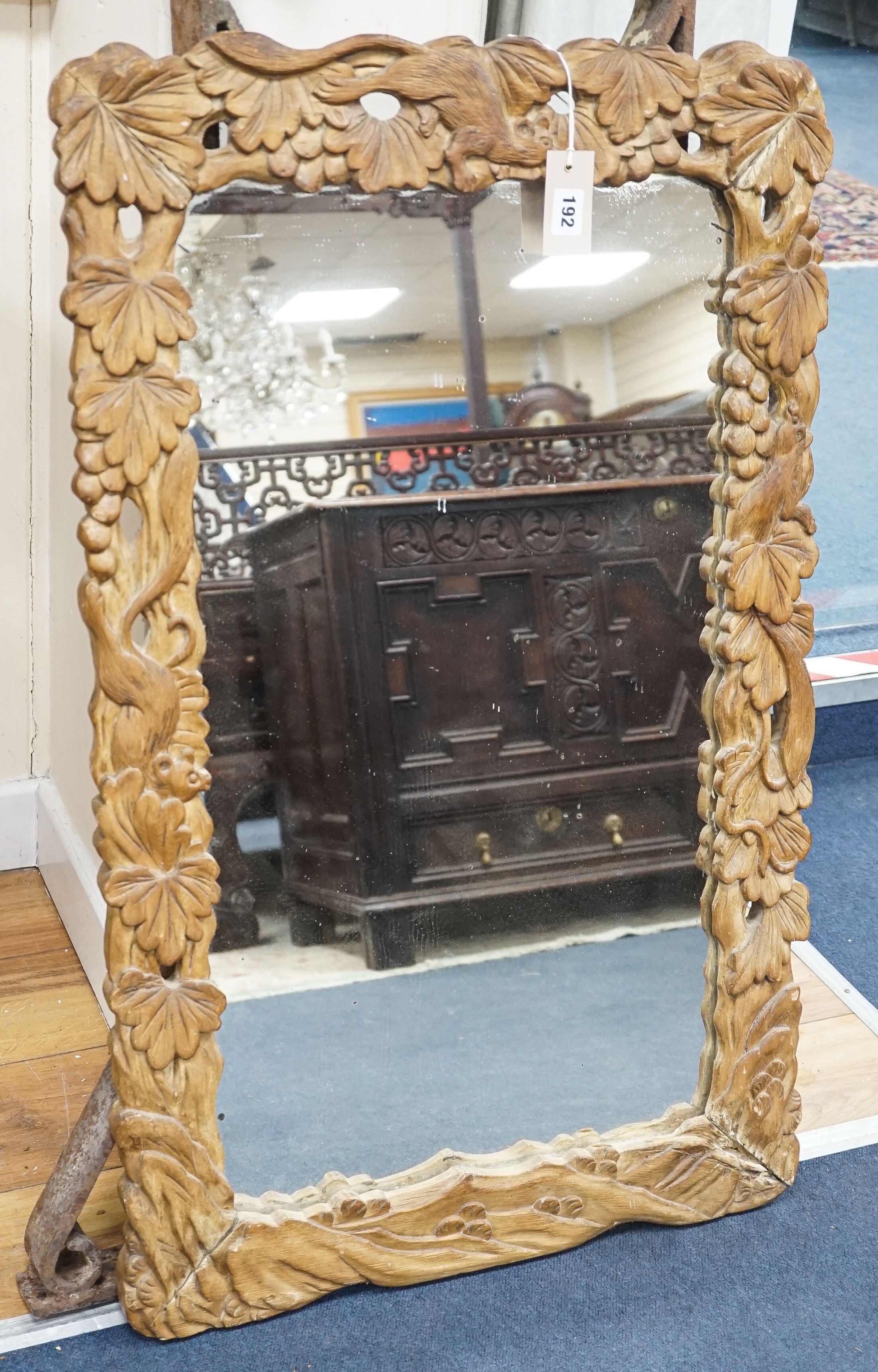 A Japanese 'squirrel and vine' rectangular carved wood mirror, width 57cm, height 96cm